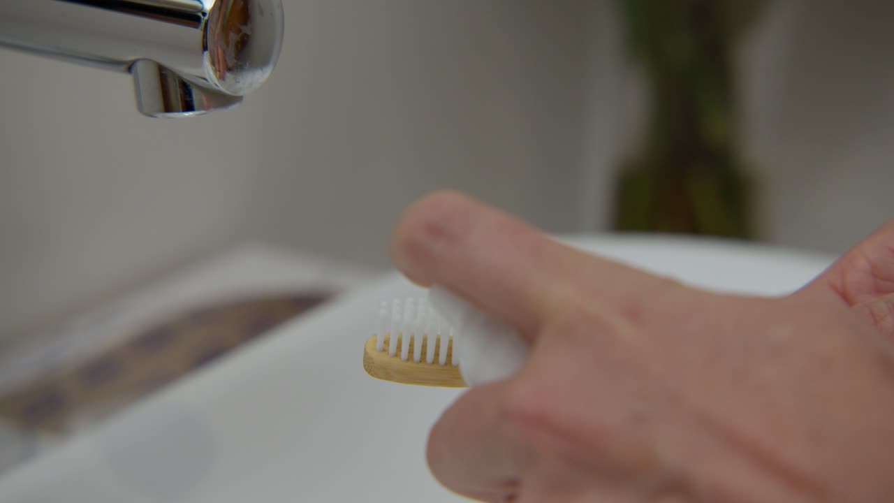 Applying foam on a tooth brush, close up