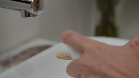 applying foam on a tooth brush, close up