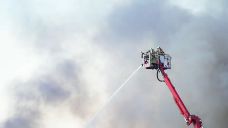 firefighters fighting a blaze with aerial platform