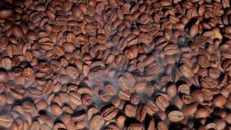 close up of seeds of coffee. fragrant coffee beans are roasted smoke comes from coffee beans.