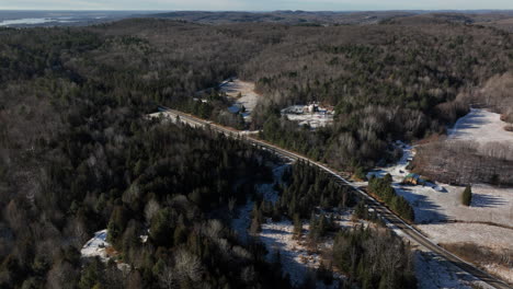 Country-Road-And-Coniferous-Forest-During-Winter---aerial-drone-shot