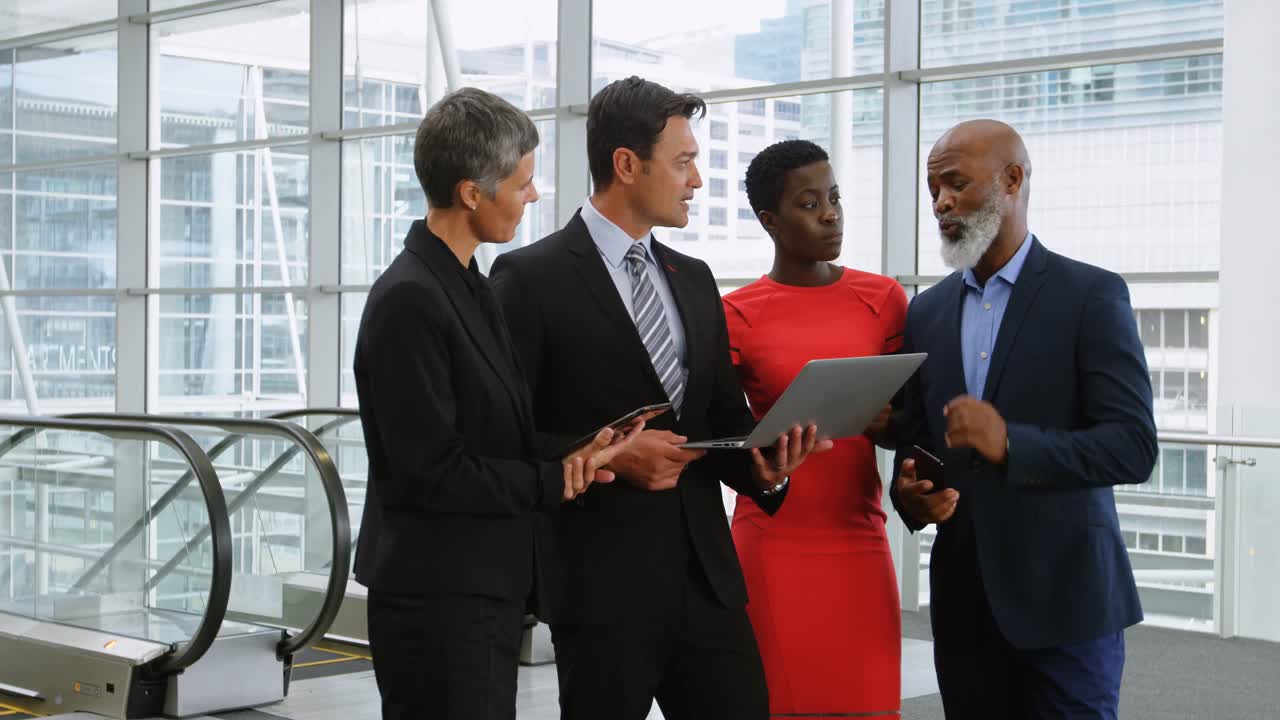 Business people discussing over laptop 4k