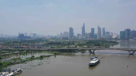 aerial shot of freighter transporting shipping containers on the saigon river on a sunny clear day