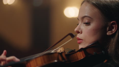 charming woman violinist is playing classic music in philharmonic hall closeup portrait of woman