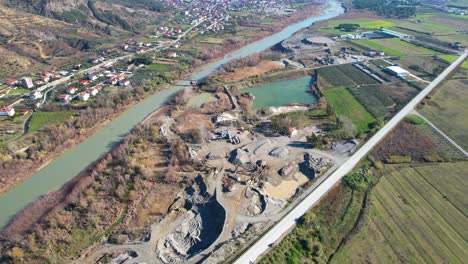 sand quarries on river bank with sand hills and ponds with water damaging the riverbed in albania