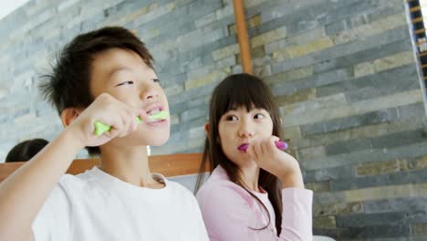 siblings brushing teeth in the bathroom 4k