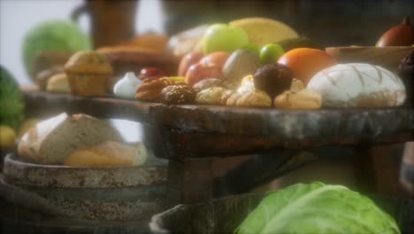 mesa de comida con barriles de vino y algunas frutas, verduras y pan