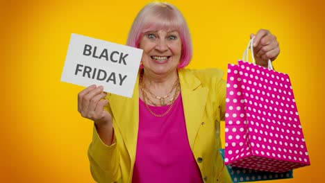 elderly granny woman showing black friday inscription banner text, advertising discounts, low prices