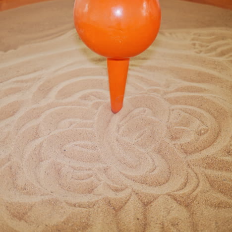 the pendulum draws on the sand. science exhibition museum.