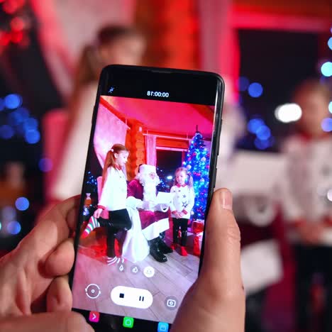 taking photo during christmas. close up of taking photos with santa claus