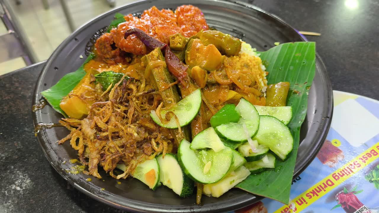 A plate of Nasi Kandar, a popular Malaysian dish. Originating from the Indian community, this meal is generously filled with rich spices and gravy