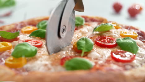 vegetarian pizza margherita cut into slices with a pizza cutter in slow motion