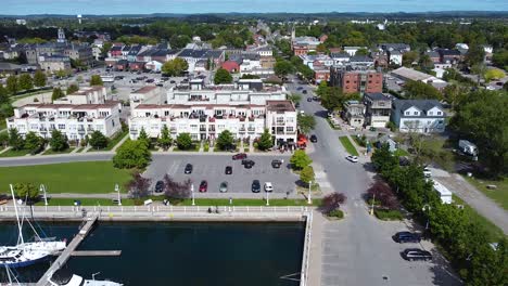 waterfront residential housing developments with views of yachts and sail boats docked in tourism town