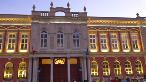 a historic building with ornate details and windows, lit up at night