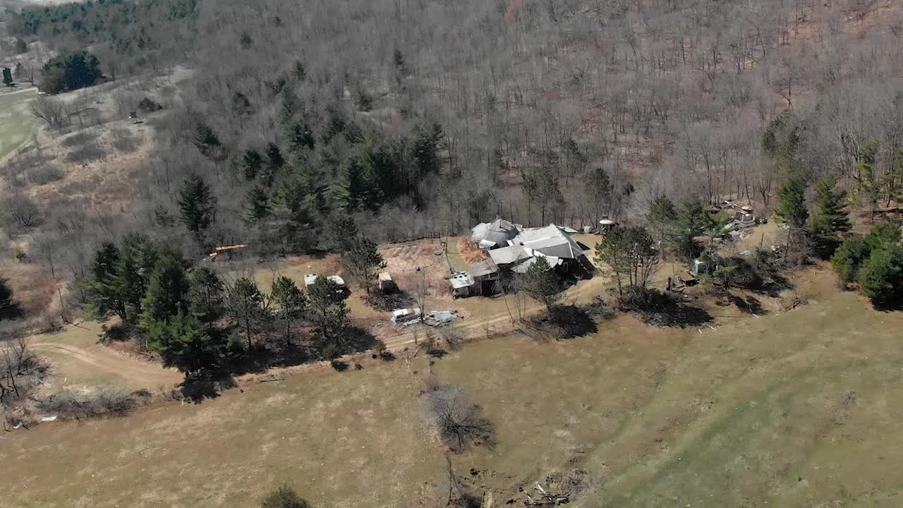 Drone circles around homestead from afar in rural Wisconsin.