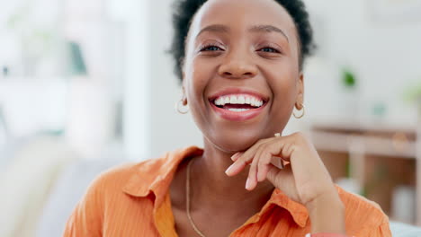 Happy,-face-and-black-woman-laughing-on-a-sofa