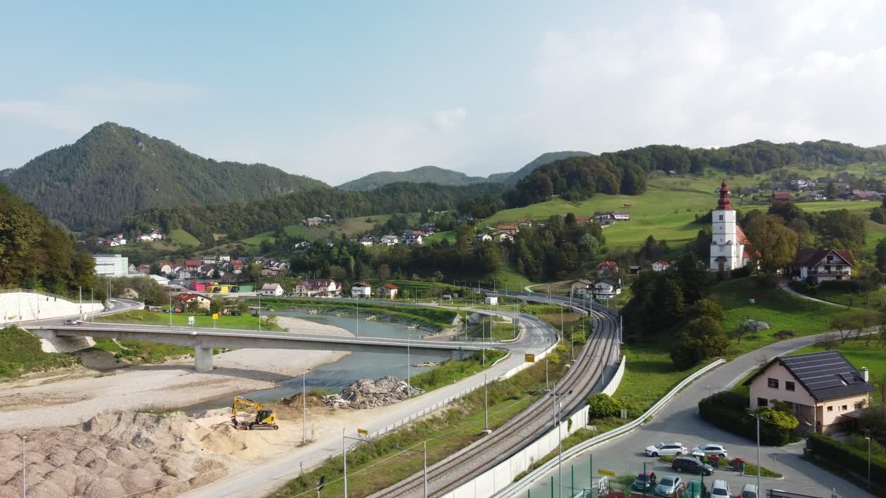 Drone pan shot of River and highways in Marija Gradec, La&scaron;ko with mountains in the background, Slovenia
