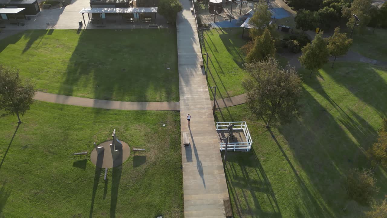 Person running alone in public park at sunset, Esperance city in Western Australia