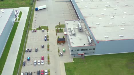 logistics park with warehouses, loading hub and a lot of semi-trailer trucks waits for load and unload goods at ramps