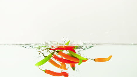 chili peppers falling in water