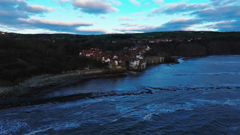 establishing aerial shot of robin hoods bay on winter morning yorkshire