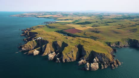 geographical wonders capturing the essence of rocky coastline of st abbs head's cliffs and lighthouse, scotland, united kingdom