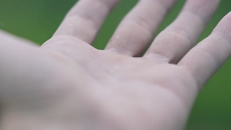 close view gentle rain falls on person hand in nasty weather