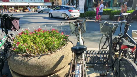 bicycles and scooters parked on a busy street