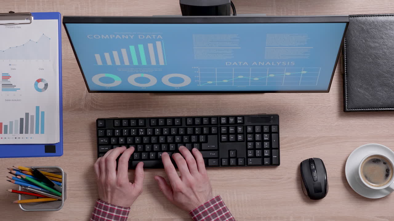 Working at a desk with computer and data analysis