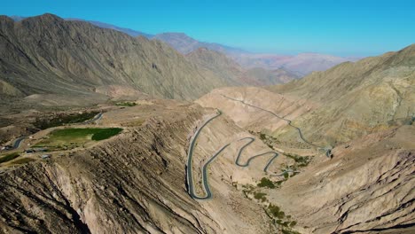 winding road with green fields and mountains of the chuquibamba district taken from the air