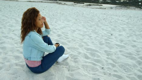 Woman-relaxing-on-beach-at-dusk-4k