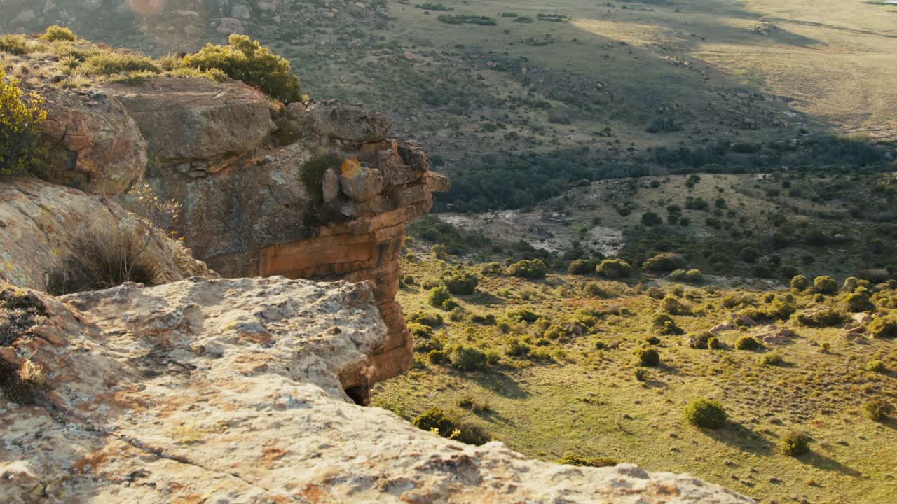 Cliffside with sunset and open nature reserve in the backdrop in Africa