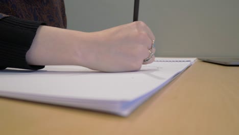 young woman designing, sketching, drawing on a pad of paper