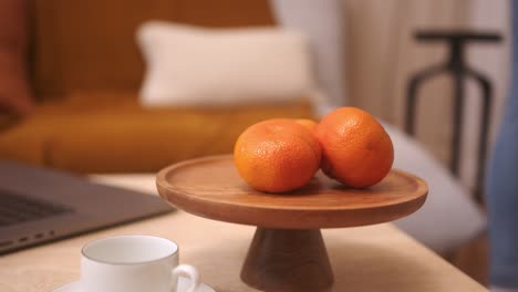 close up shot of a table centerpiece with some mandarins on