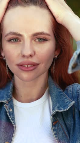 woman with red hair wearing denim jacket and white t-shirt