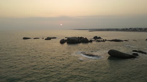 aerial drone shot of kanyakumari showcasing the serene ocean and bustling city at twilight.