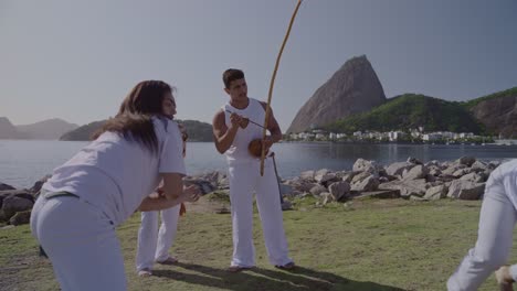 people practicing capoeira outdoors in rio de janeiro, brazil