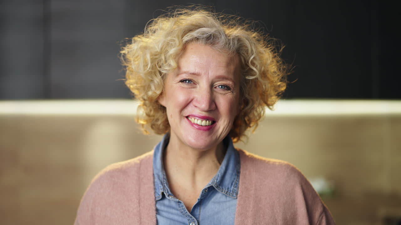 Portrait of a smiling woman with blonde curly hair