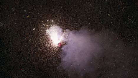 fireworks sparklers exploding on asphalt