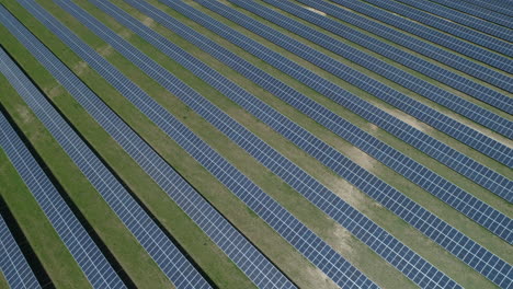 Establishing-Drone-Shot-Rotating-Around-Field-of-Solar-Panels-on-Solar-Farm-on-Sunny-Day