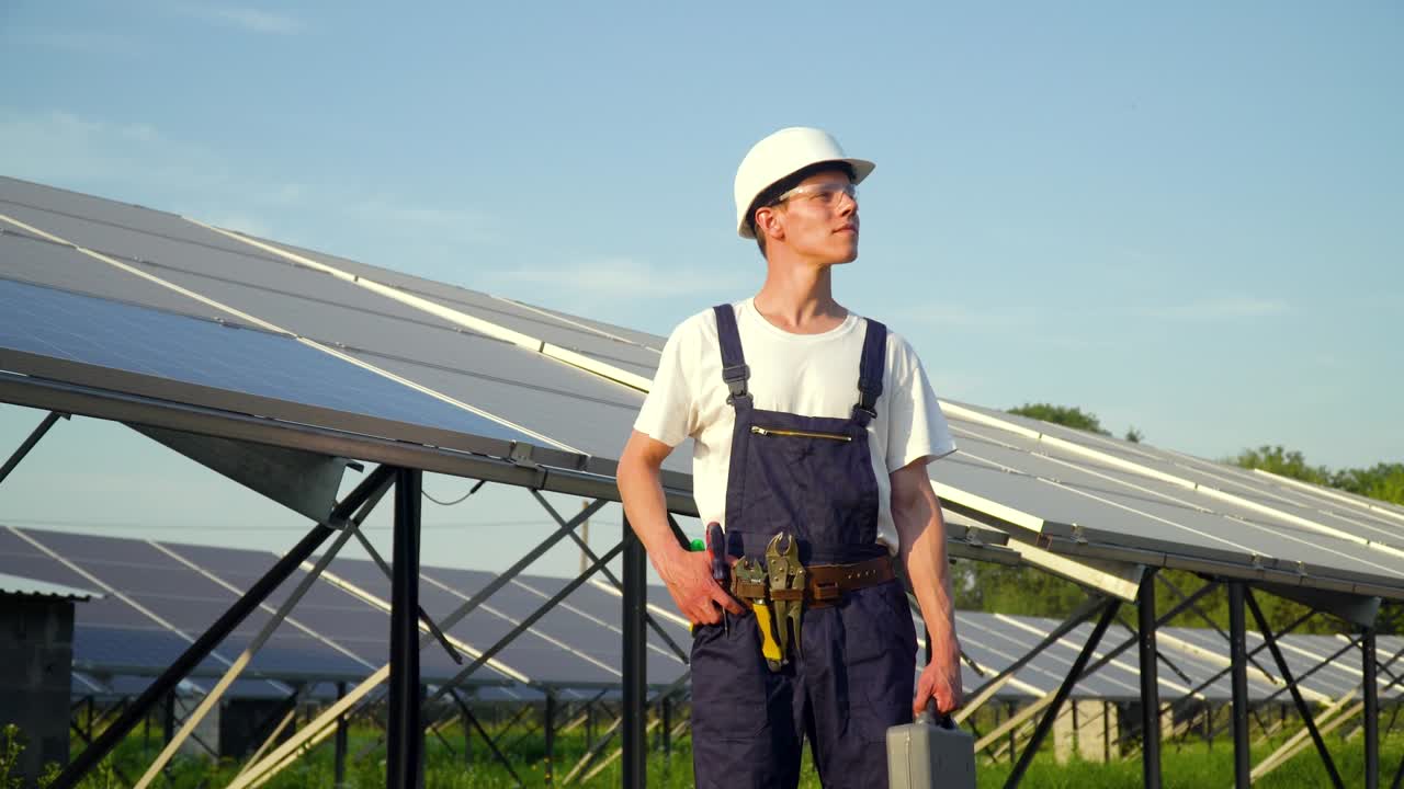 Solar panel technician working with solar panels at sunset. The future is today