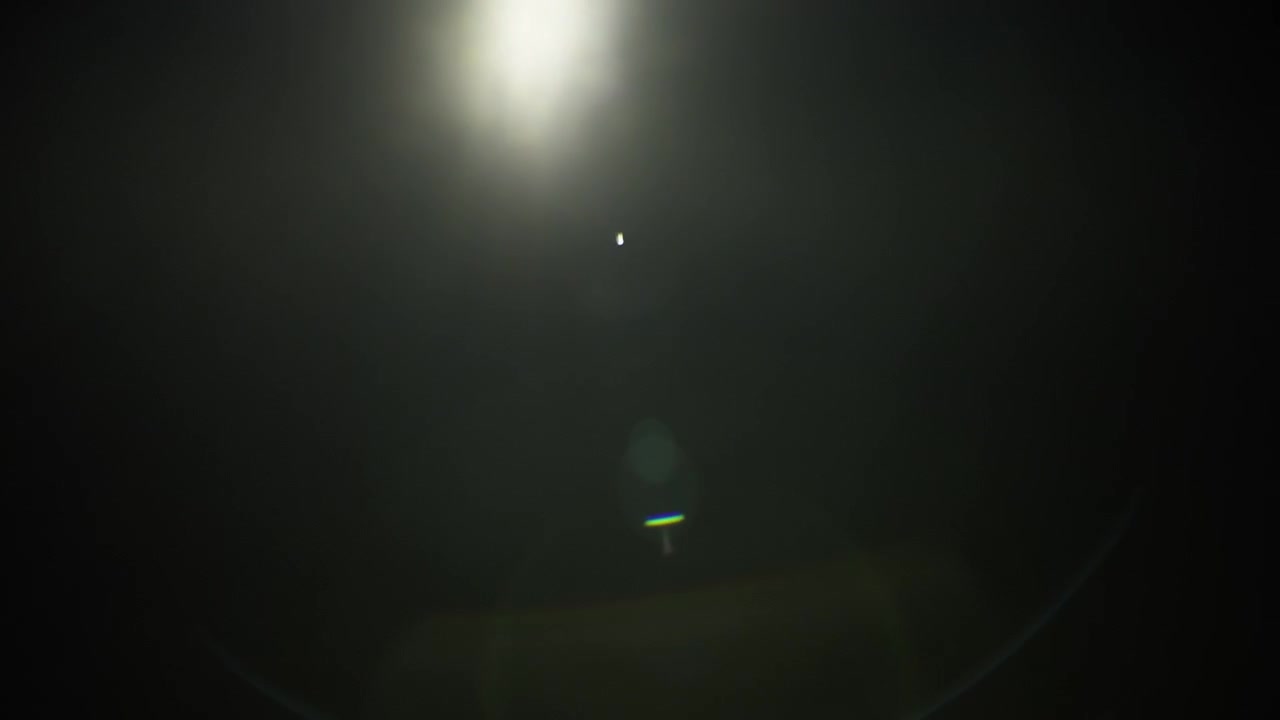 Lens flare overlay fading out to black background. Slow motion