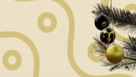 swinging black and gold christmas baubles over gold curves and ring pattern on beige background