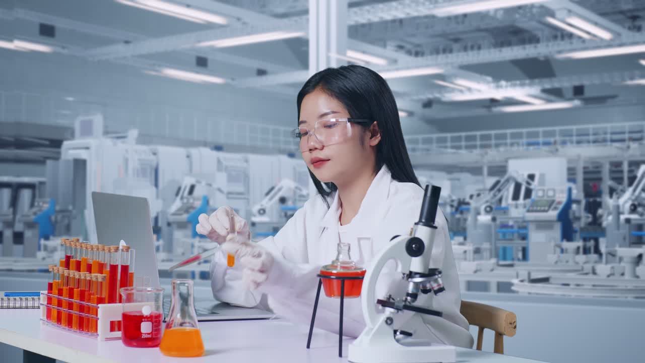 Side View Of Asian Woman Scientist Making Experiment With Test Tube, Typing On A Laptop, Celebrating Success In Laboratory With Microscope. Working In The Lab Analyzing Finding Sample Test Tube