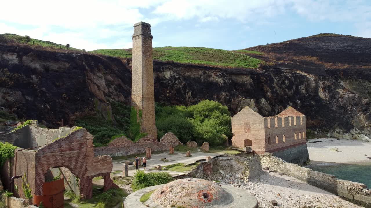 Cinematic aerial revealing shot of the remains of the Porth Wen Brickworks in Anglesey, North Wales, Europe