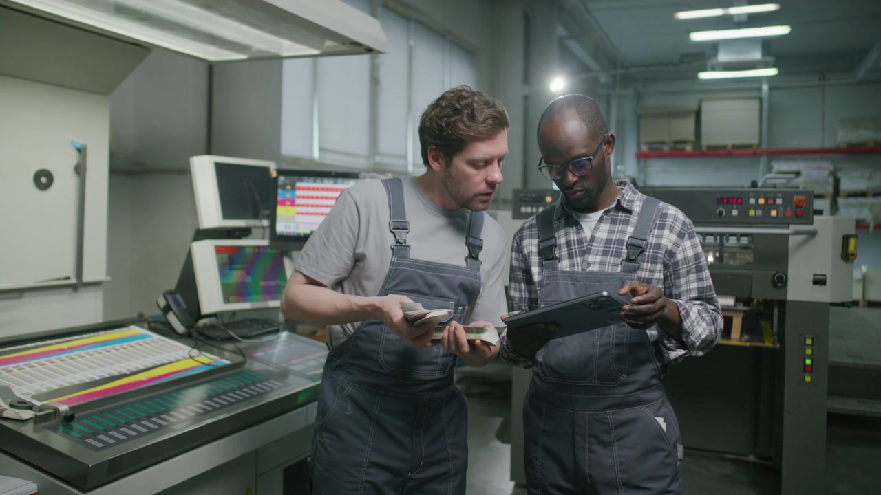 Printing House Technicians Discussing Color Samples and Using Tablet