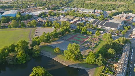 Four-outdoor-tennis-courts-shaded-by-the-green-trees-in-Hillsborough-Park-of-the-local-tennis-club-in-Sheffield-right-on-the-English-motorway-A61