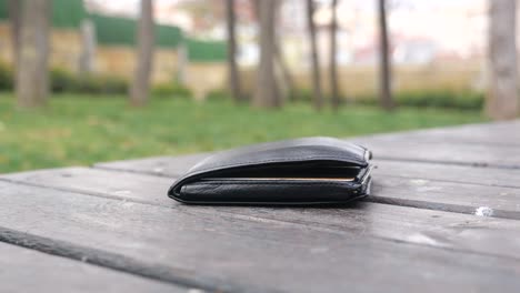 lost black wallet on a park bench