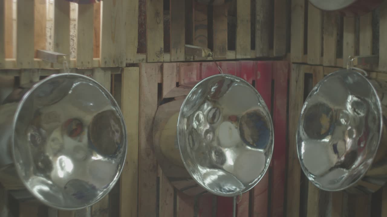 Wall of Steel pans or oil drums hanging on display wall