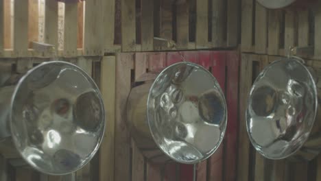 wall of steel pans or oil drums hanging on display wall